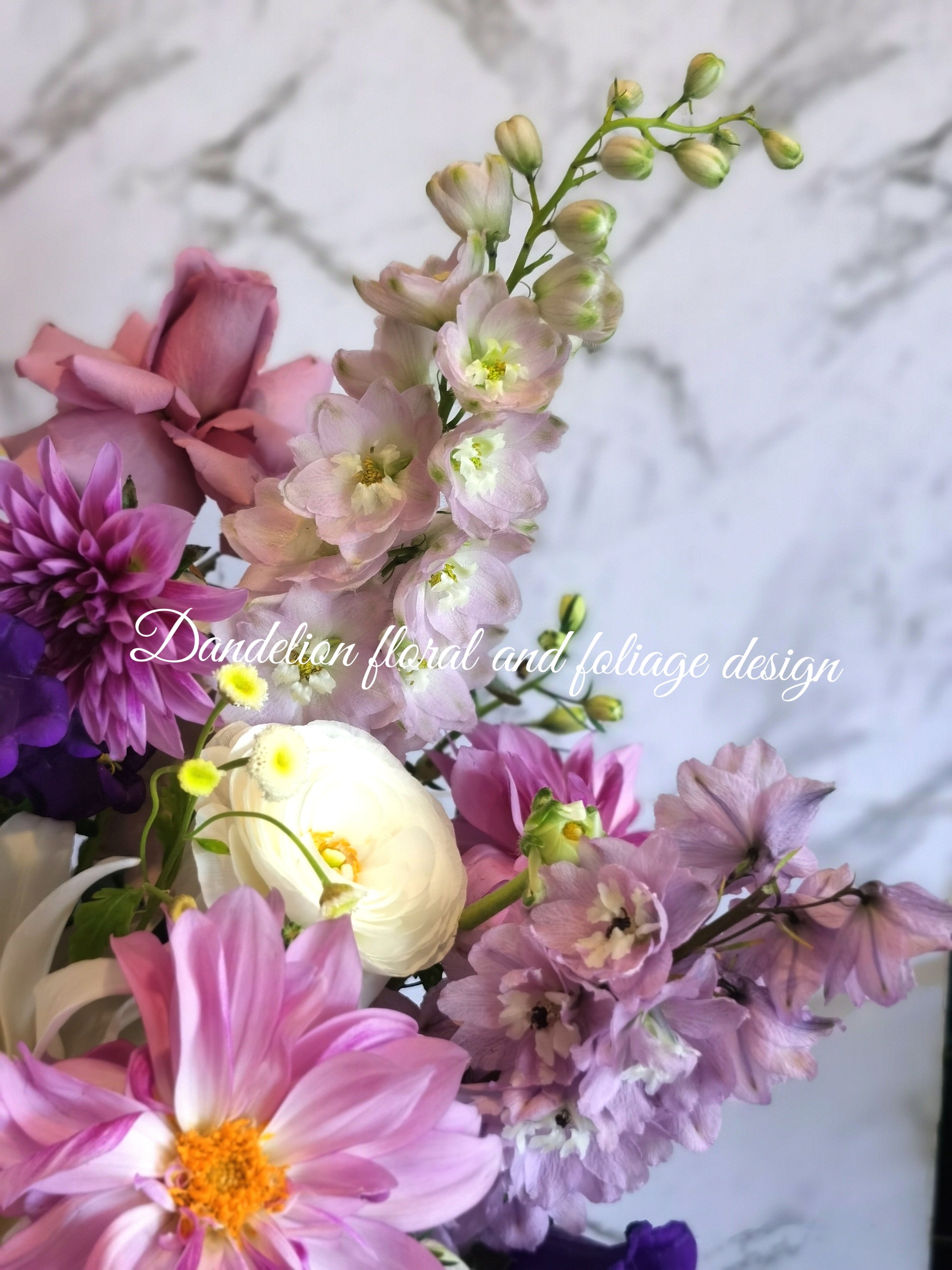 This resplendent selection of blue, mauve and purple flowers artfully arranged into a box arrangement makes an ideal gift for all.