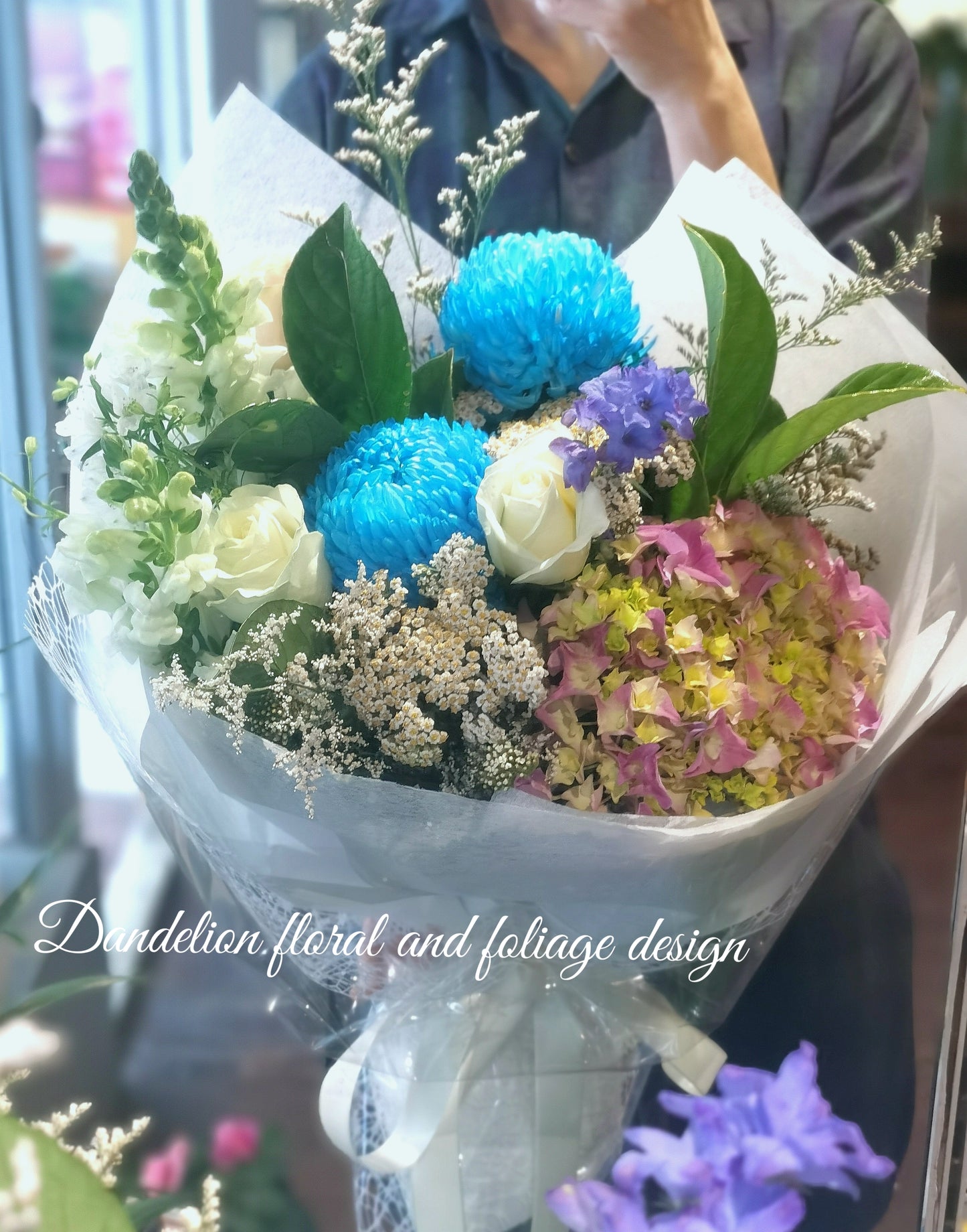 This purple/blue bouquet uses cool tones using seasonal flowers and complimenting greenery.