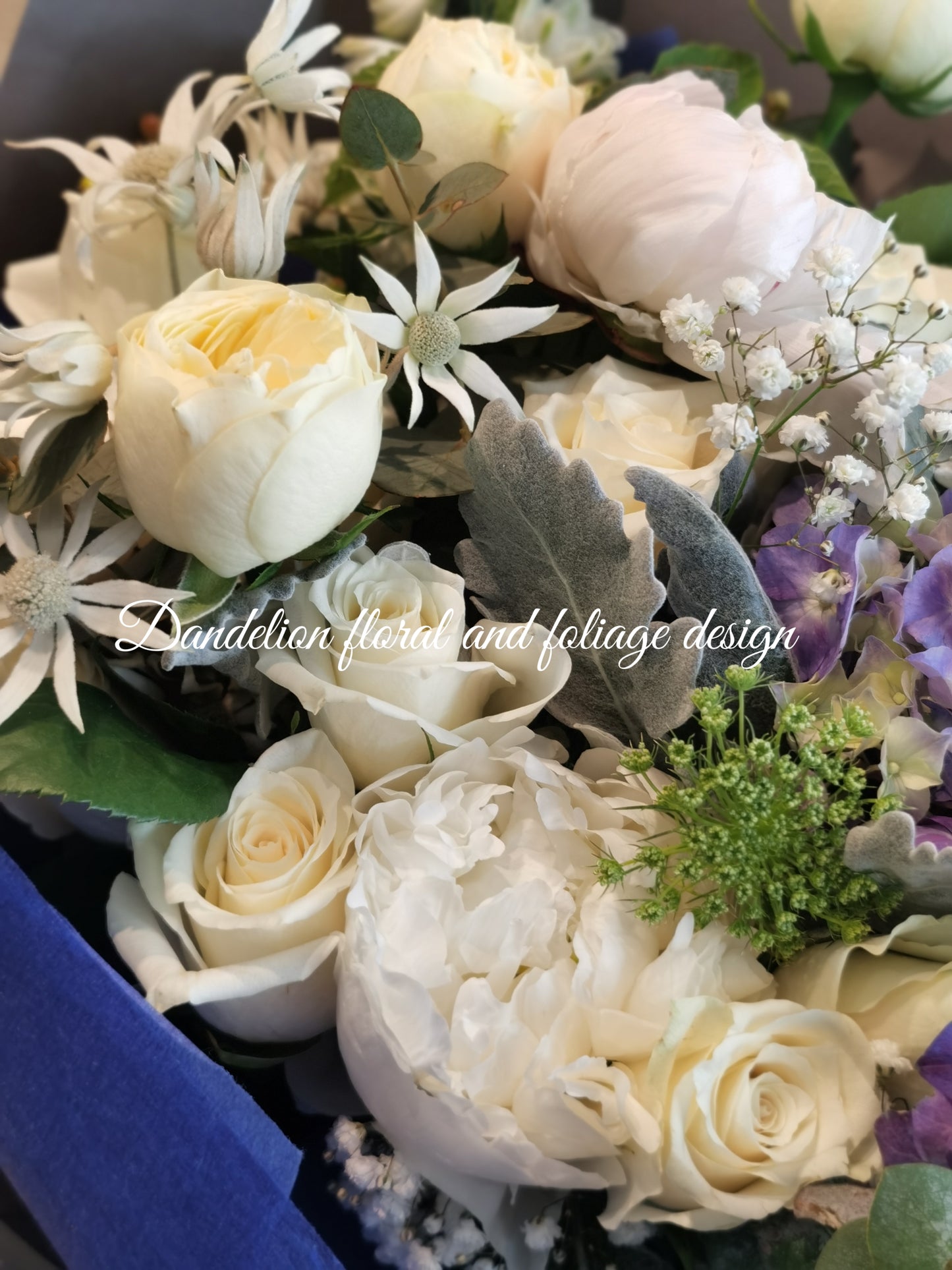 This blue bloom bouquet uses cool tones with seasonal flowers and complimenting greenery. This is a perfect gift to celebrate occasions for baby boy, graduation, birthday, anniversary and more.