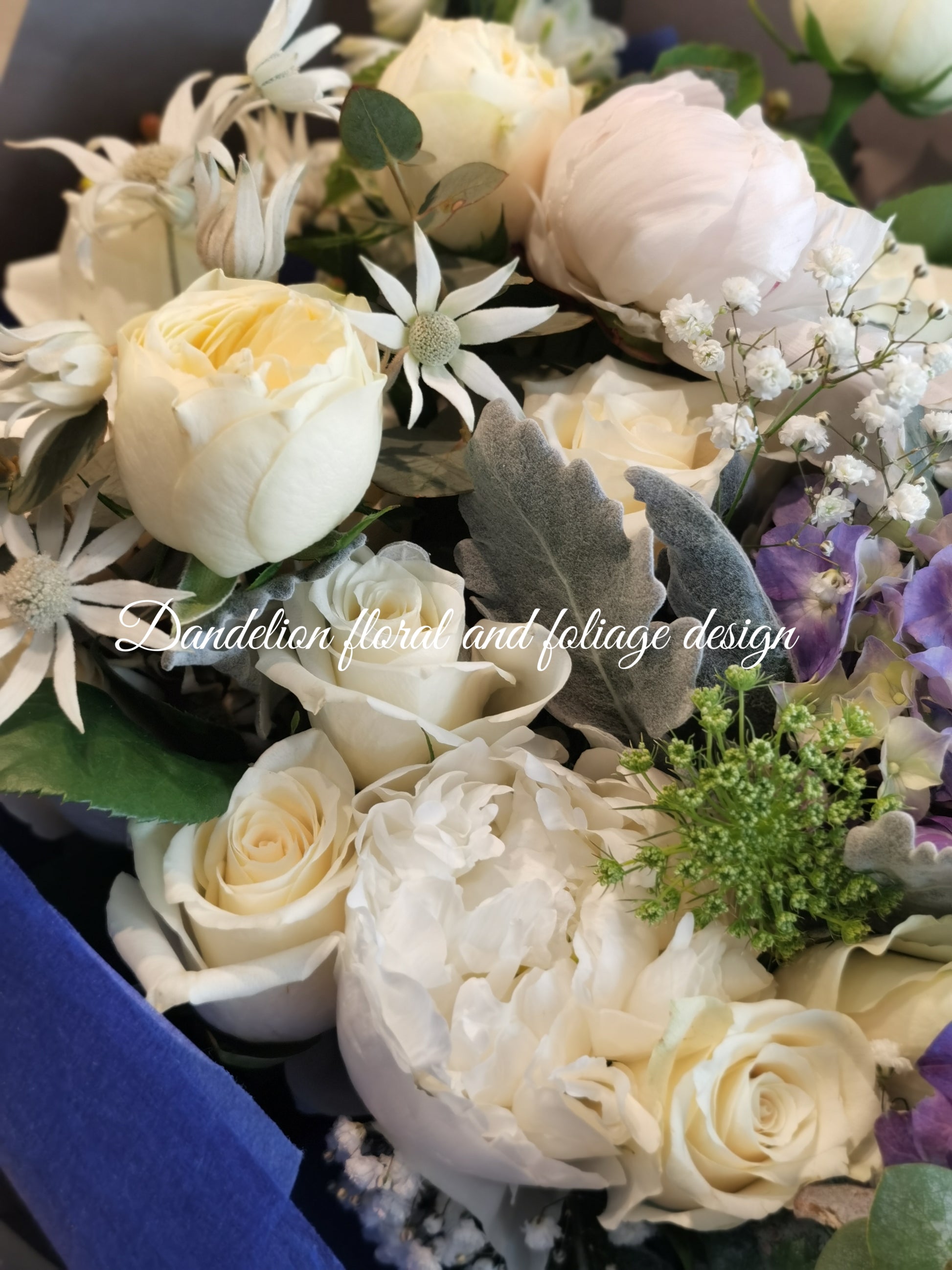 This blue bloom bouquet uses cool tones with seasonal flowers and complimenting greenery. This is a perfect gift to celebrate occasions for baby boy, graduation, birthday, anniversary and more.
