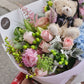 A graduation bouquet featuring a mix of pastel colored flowers and greenery, wrapped with a ribbon, alongside a plush toy bear. Lush bouquet using seasonal blooms in pastel tones complimented with seasonal greenery.
Our Graduation Flowers are the perfect way to send your best wishes and honour their hard work and dedication. With an added special touch our graduation bear - the perfect keepsake.