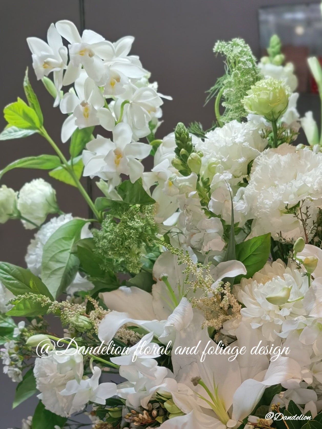 Lush stands tall filled with white Oriental Lilies, Lisianthus, Gladioli and Viburnum leaves. It is 1100mm tall, 500mm wide.