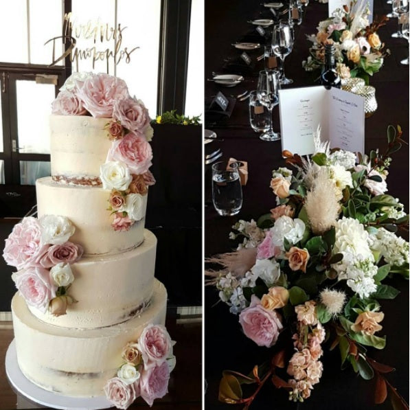 Three-tier wedding cake with floral decorations and a floral arrangement on a table.