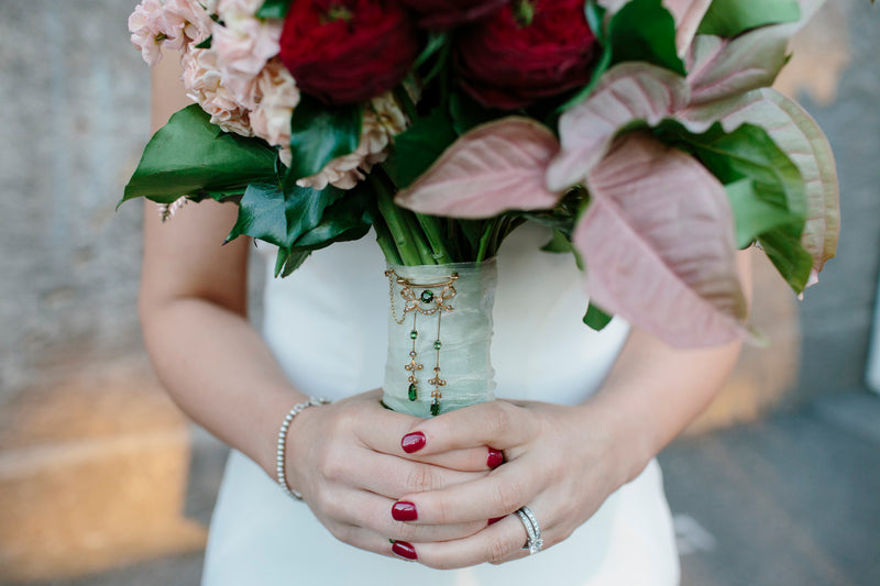 Person holding a bouquet of flowers with a blurred background