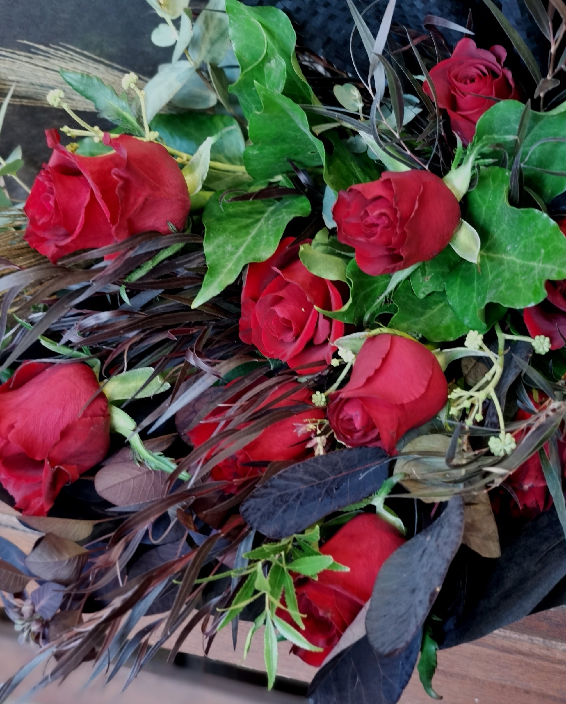 The classic romantic gesture. A dozen of premium long stem red roses complimented with a variety of greenery for added texture and style.