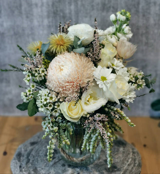 Elegant white and cream flower arrangement with roses and seasonal blooms in Vase