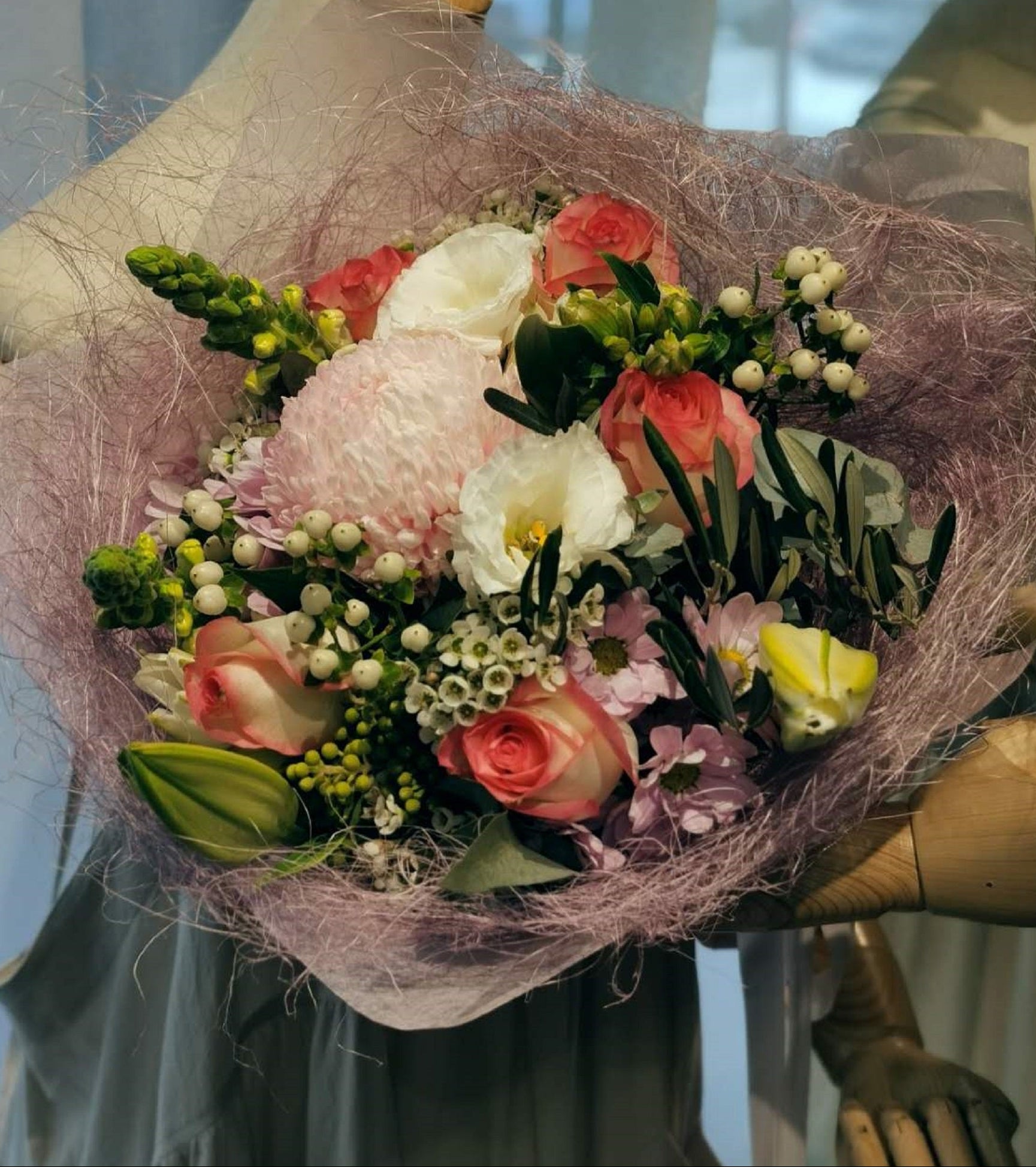 This gorgeous flower bouquet have oriental lilies disbud mums, lisianthus, roses and snapdragons and etc. These stunning blooms are highlighted by a range of foliage like wax, gum and dusty miller. These winter flowers are ideal for any occasions. Available with pastel, white and orange colours.