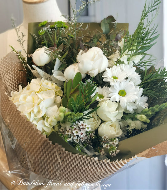 This white bouquet is made from a selection of White Hydrangea, White peony, Snapdragon, Chrysanthemum, White roses. Height: 500mm; Diameter: 400mm